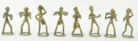 Eight brass Ashanti type weights, depicting musicians,