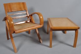 A 20th century folding armchair with caned seat, together with a matching footstool,