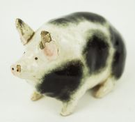 An early R H & S Weymss ware model of a pig, with black sponged decoration,