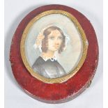 A miniature of a young lady in a brass frame in older miniature frame