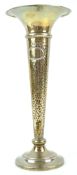 A silver trumpet vase with flared lip over a split hammered body, on a plain loaded foot,