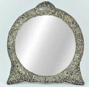 A silver mounted strut back dressing table mirror, of round form,