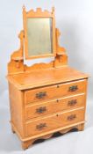 A Victorian pine dressing table with original paint work, the swing mirror above three long drawers,