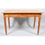 A rectangular pine table, with two frieze drawers on turned legs, 77cm high x 120cm wide x 69.