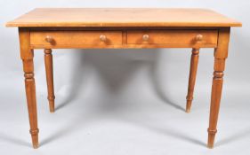 A rectangular pine table, with two frieze drawers on turned legs, 77cm high x 120cm wide x 69.