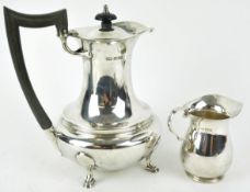 A silver coffee pot, of plain rounded baluster form, with domed cover, raised on four cabriole feet,