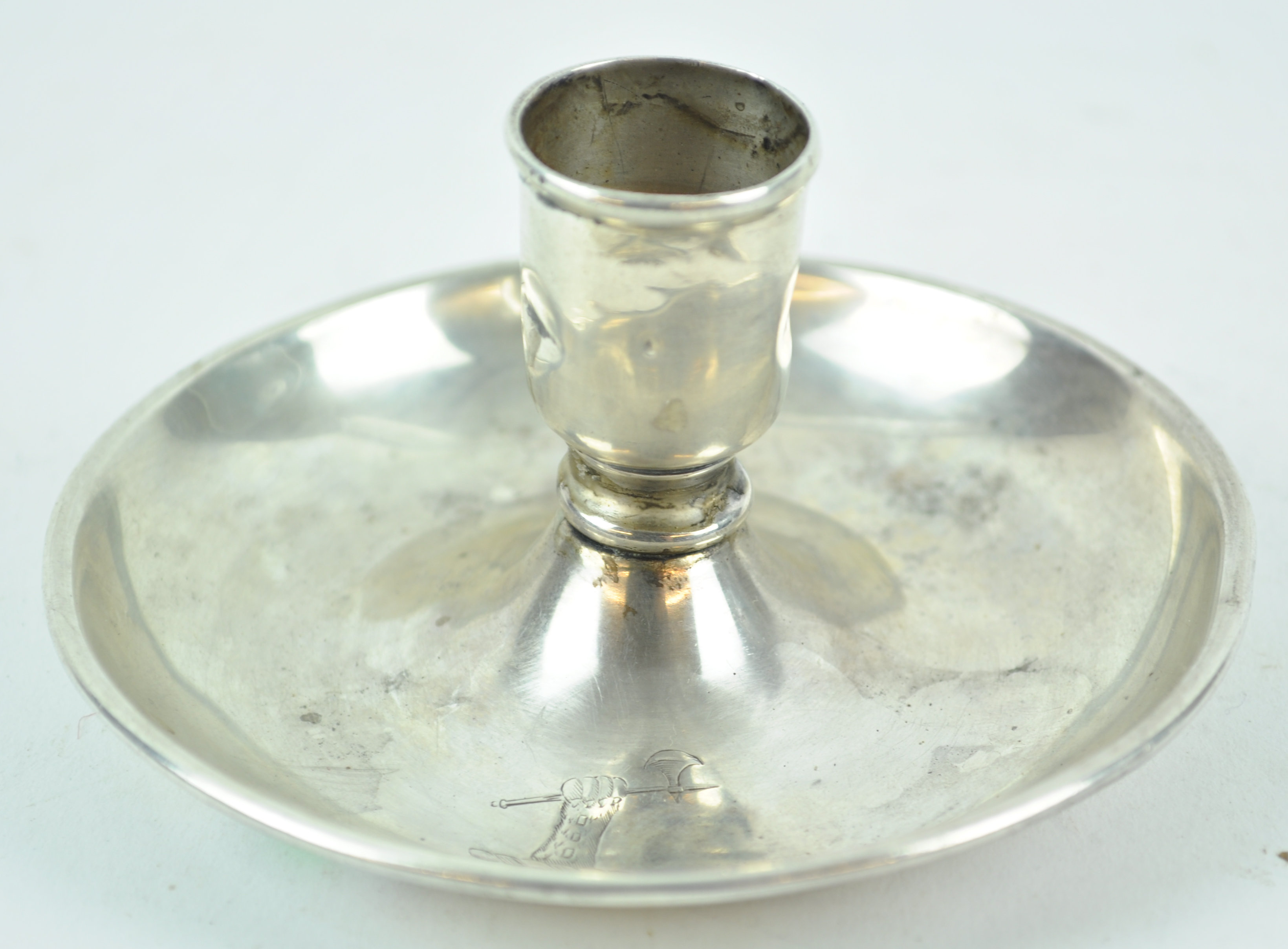 An unusual candlestick, in the form of a go to bed, with no handle,