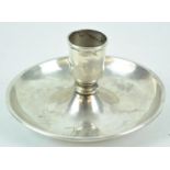 An unusual candlestick, in the form of a go to bed, with no handle,