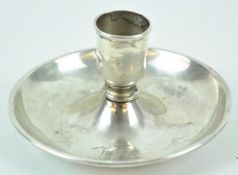 An unusual candlestick, in the form of a go to bed, with no handle,