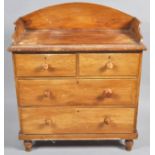 A Victorian pine chest with raised back above two short and two long drawers on turned legs, 106.