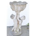 A reconstituted stone garden urn, the support modelled as two children,