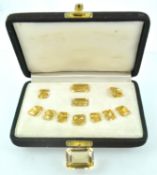 A suite of eleven rectangular faceted cut citrine quartz stones of variable sizes.