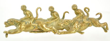 An early 20th century brass paperweight, modelled as three monkeys riding dogs, 12.