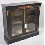 A Victorian ebonised pier cabinet, the frieze with marquetry flowers,