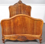 A 20th century French walnut bed frame, scroll carved top rail with headboard,