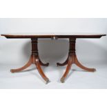 A 20th century mahogany twin pedestal oval dining table with two leaves and runners 72cm x 107cm x