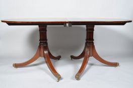 A 20th century mahogany twin pedestal oval dining table with two leaves and runners 72cm x 107cm x