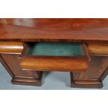 A Victorian mahogany pedestal sideboard with raised back above three frieze drawers and two