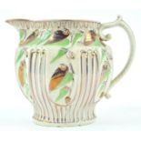 A 19th century moulded jug with pink lustre and green enamel decoration, circa 1820, 12.