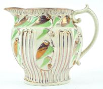 A 19th century moulded jug with pink lustre and green enamel decoration, circa 1820, 12.