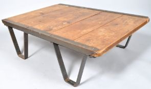 An Industrial iron mounted palette table with five plank top,