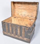 A Continental domed top trunk with oak binding and decorative iron mounts, 54.