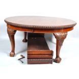 A Chippendale style mahogany 'D'end dining table with gadrooned edge on massive carved legs with