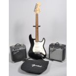 A 'Fender Squier Strat' electric guitar, two Squier SP10 amps,
