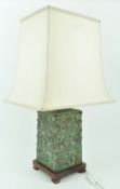 A Chinese table lamp, with silk shade above bronze patinated rectangular base,