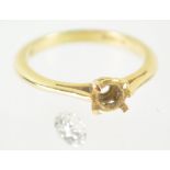 A yellow metal four claw single stone ring together with a loose round brilliant diamond estimated