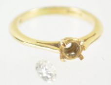 A yellow metal four claw single stone ring together with a loose round brilliant diamond estimated