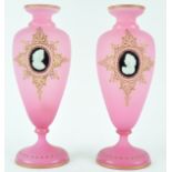 A pair of Victorian pink frosted glass vases, with gilt jewelling, each applied with a cameo,
