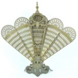 A brass peacock feather fan fire screen,