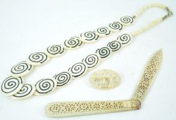 A pierced bone folding letter/paper knife a similar necklace and s brooch (3)