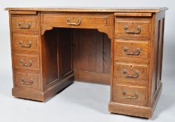 An oak kneehole desk with a central drawer flanked by four drawers to either side, on plinth base,