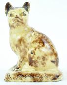 A Staffordshire creamware model of a seated cat of Whieldon type, enriched in a tortoishell glaze,