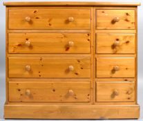 A 20th century pine chest of four short and four long drawers on plinth base,