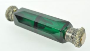 A double ended green glass scent bottle with panel cut body with white metal hinged and screw off