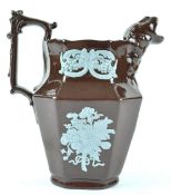 A mid 19th century brown glazed ice jug with blue applique decoration, circa 1860, 17.