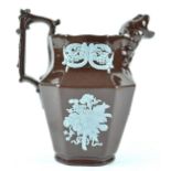 A mid 19th century brown glazed ice jug with blue applique decoration, circa 1860, 17.