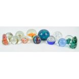 A collection of thirteen 20th century glass paperweights,