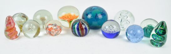 A collection of thirteen 20th century glass paperweights,