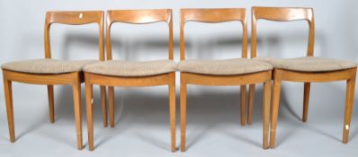 A set of four 1970's dining chairs with shaped cresting rail,
