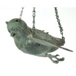 A cast alloy incense burner, in the form of a bird with outstretched wings,