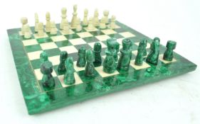 A chess board, set malachite and white stone, with similar figures,