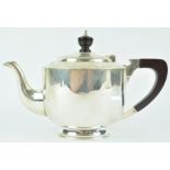 A silver teapot, of very plain cylindrical form with domed cover, on a flared foot,