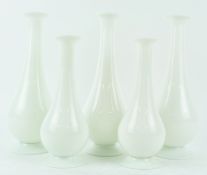 Five opaline glass vases, of bottle shape, on spreading feet, in sizes 29.