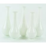Five opaline glass vases, of bottle shape, on spreading feet, in sizes 29.