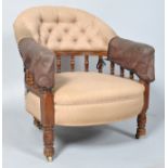 A Victorian button back armchair, with turned uprights,