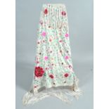 A Chinese fringed shawl, embroidered with highly coloured flowers, 122cm square,